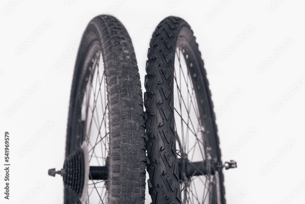 Old and new bicycle tires, comparison of an old tire with worn spikes and a new bicycle tire, the concept of timely replacement of tires for transport Old and new bicycle tires, comparison of an old tire with worn spikes and a new bicycle tire, the concept of timely replacement of tires for transport