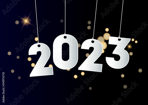 Happy new year 2023. Hanging white paper number on a colorful bokeh  background. Holiday greeting card design.