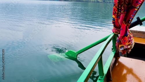 close up slow motion shot with green oars dipping into blue green water on the shikara type row boats in nainital naukuchiatal bhimtal showing detail shot for this tourist attraction photo