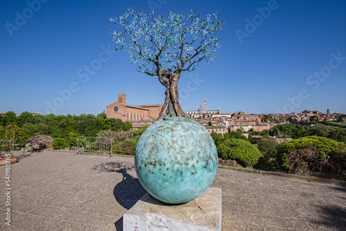 SIENA, ITALY - May, 2022: cityscape. View of sculpture "Terra Mater. Earth and Heaven" by Andrea Roggi in Siena, Italy.