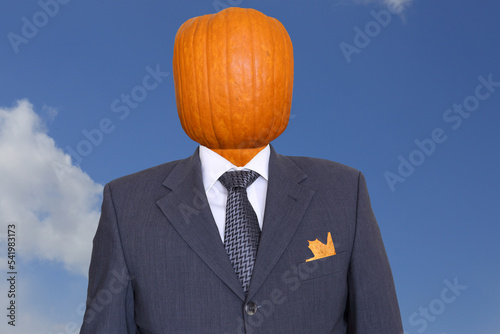man in a business suit with a pumpkin instead of a head
