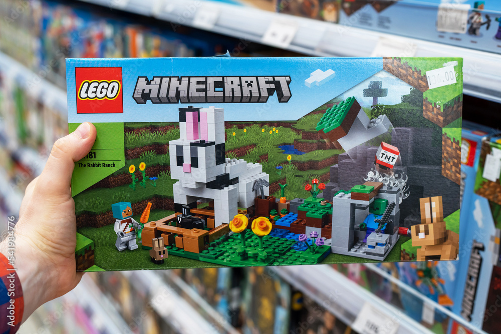 Fototapeta premium Lego Minecraft constructor in hands of buyer. Lego is a popular line of construction toys manufactured by the Lego Group. Minsk, Belarus, 2022