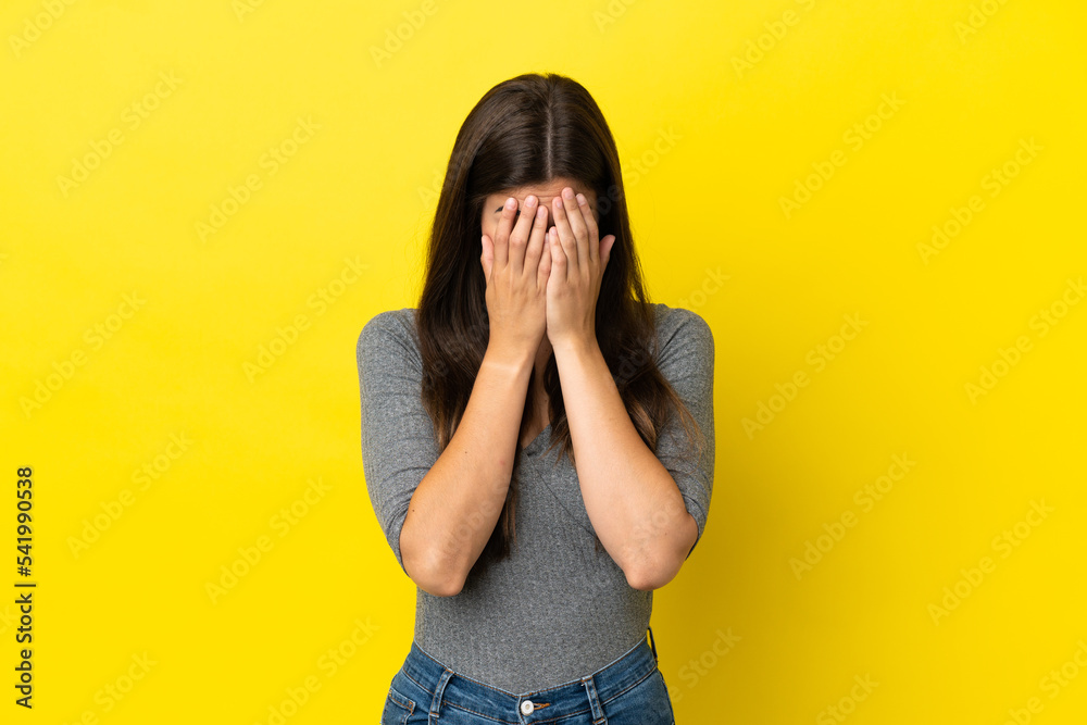 Young Brazilian woman isolated on yellow background with tired and sick expression Young Brazilian woman isolated on yellow background with tired and sick expression