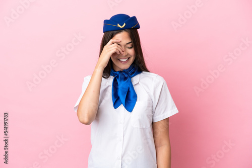 Airplane stewardess Brazilian woman isolated on pink background laughing