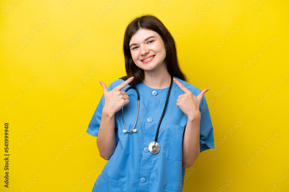 Young surgeon doctor Russian woman isolated on yellow background giving a thumbs up gesture Young surgeon doctor Russian woman isolated on yellow background giving a thumbs up gesture