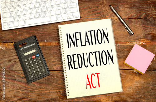 notebook with Inflation Reduction Act concept near calculator and keyboard photo