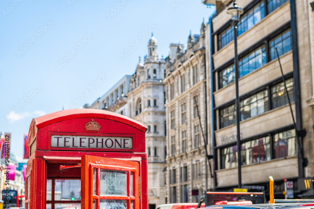 European red telephone phone box booth closeup with opened door in London, United Kingdom at Piccadilly circus street in summer European red telephone phone box booth closeup with opened door in London, United Kingdom at Piccadilly circus street in summer