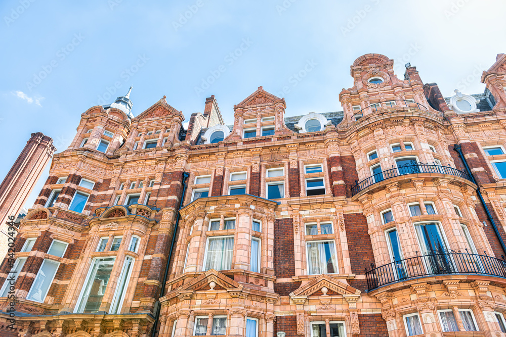 Apartment flats house building in Gothic revival style architecture in Mayfair, Westminster of London UK by Park lane street road near Hyde park