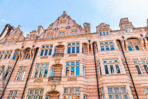 Apartment flats house building in Gothic revival style red brick architecture in Mayfair, Westminster of London UK by Hyde Park lane street road photo