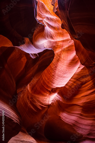 Wide angle vertical view of shadows and light at upper Antelope slot canyon with wave shape abstract sandstone rock formations of red orange layers