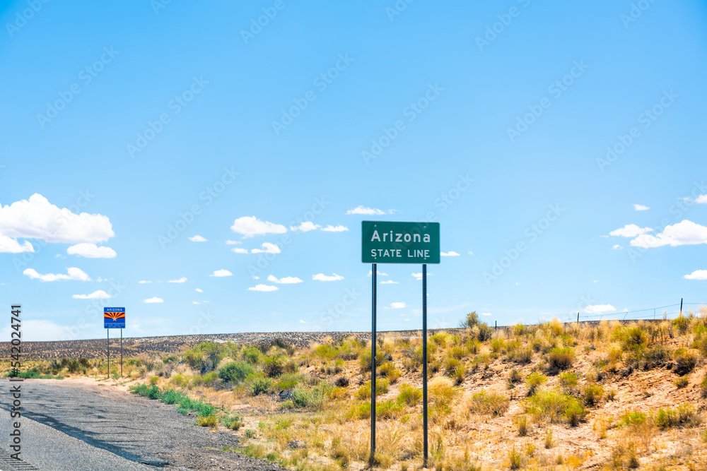 Obraz premium Page, USA with state line border with welcome to Arizona sign entering from Kanab, Utah with summer desert barren dry landscape