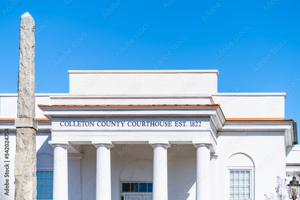 Fototapeta premium Walterboro, USA Colleton county courthouse clerk of court building sign at white architecture facade in South Carolina city