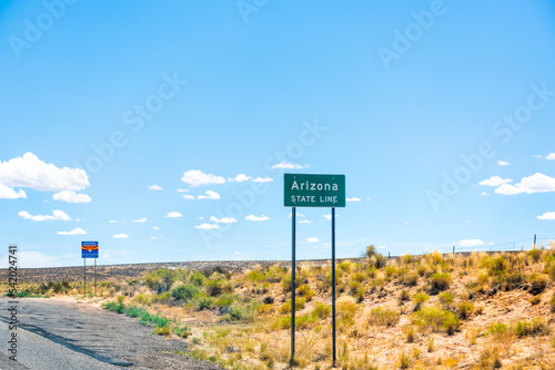 Page, USA with state line border with welcome to Arizona sign entering from Kanab, Utah with summer desert barren dry landscape