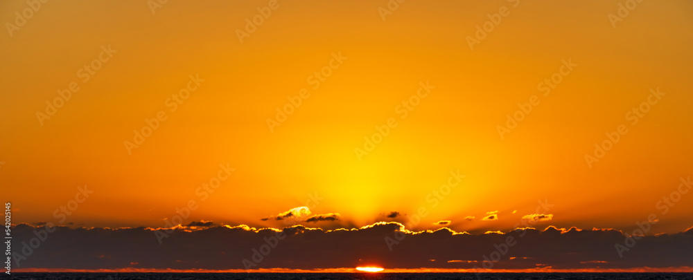 Cloud strip clear orange sunset over sea. Background. Copy space. Text space.
