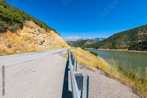 Colorado Rocky Mountains with Paonia reservoir lake with dam and closeup of guardrail at highway 133 near Redstone, Colorado photo