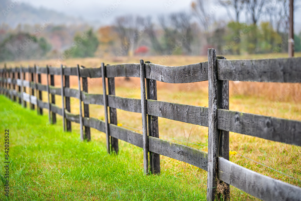 Wooden farm fence in Roseland, Virginia by Blue Ridge parkway mountains in autumn colorful fall with Nelson County rural countryside landscape