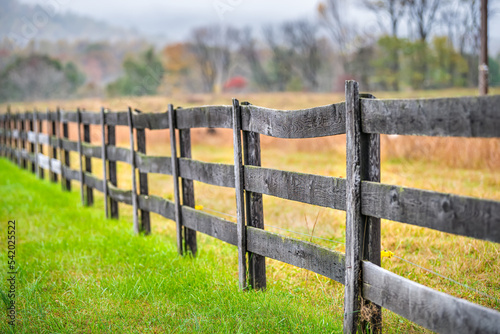 Wooden farm fence in Roseland, Virginia by Blue Ridge parkway mountains in autumn colorful fall with Nelson County rural countryside landscape photo