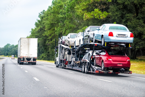 Truck trailer hauler transportation, commercial transport hauling brand new cars for auto dealership on Florida highway road © Andriy Blokhin