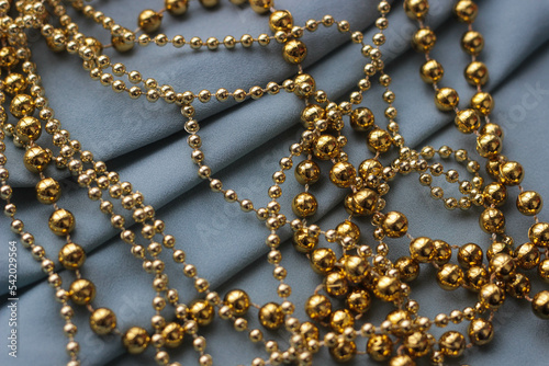 golden shiny beads for home decoration, Christmas trees for holidays and parties - new year, christmas. elegant background