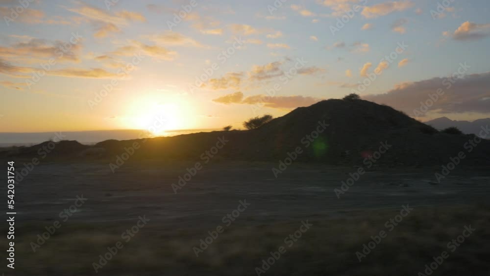 The road goes by at sunset over the ocean, filmed from a car, in New Zealand The road goes by at sunset over the ocean, filmed from a car, in New Zealand