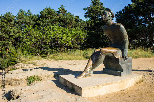 Kislovodsk, Stavropol Territory, Russia - July, 23, 2022: bronze statue of Russian writer Mikhail Yuryevich Lermontov on a mountain with a panoramic view, made by sculptor N.V. Khodov in 2006 photo