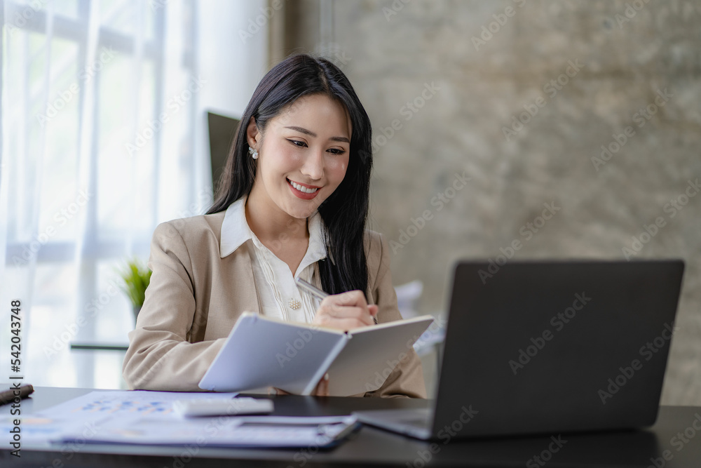 Asian businesswoman working in finance and calculator working with laptop computer with paper documents at office Technology market and financial concepts Asian businesswoman working in finance and calculator working with laptop computer with paper documents at office Technology market and financial concepts