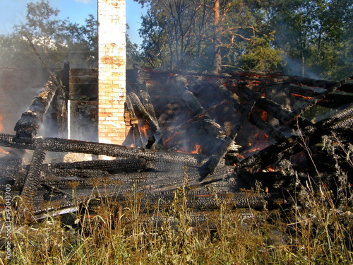 Russian firefighters at work. Extinguishing a burning wooden house. Leningrad region, Russia.