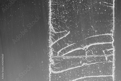 Wall Mural Strip of tape adhesive on a glass surface after being pulled.