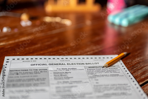 Selective focus on a generic election ballot with a pencil on top.
