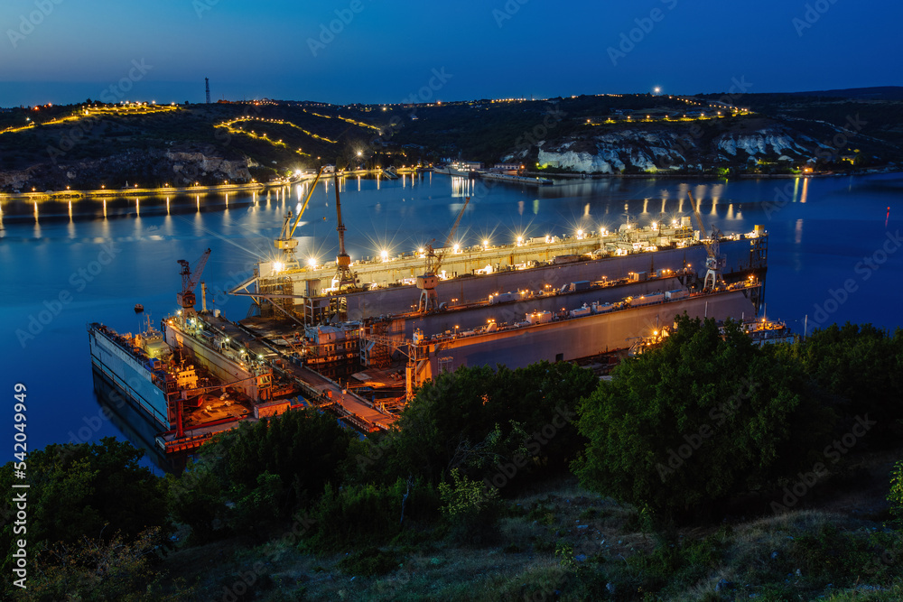 Ship repair dry docks at night, aerial view