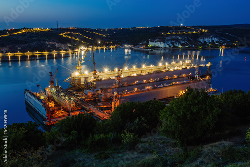 Ship repair dry docks at night, aerial view