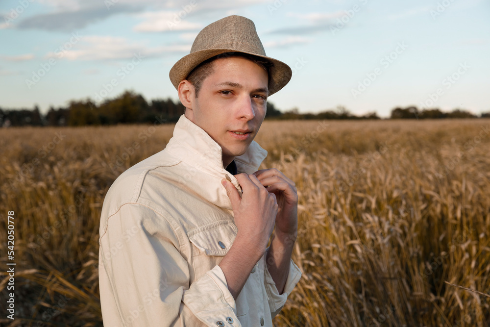 Man in hat and shirt walking in field Man in hat and shirt walking in field