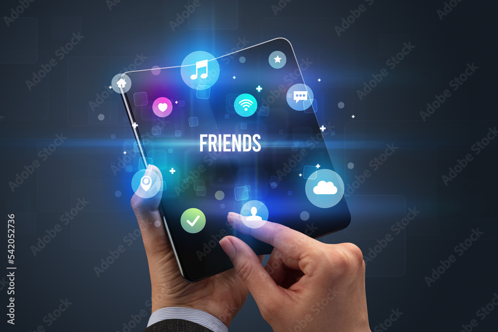 Fototapeta premium Businessman holding a foldable smartphone