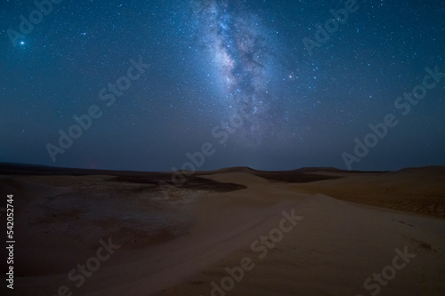 Milky way stars in desert at dark night above sand dune, empty quarter