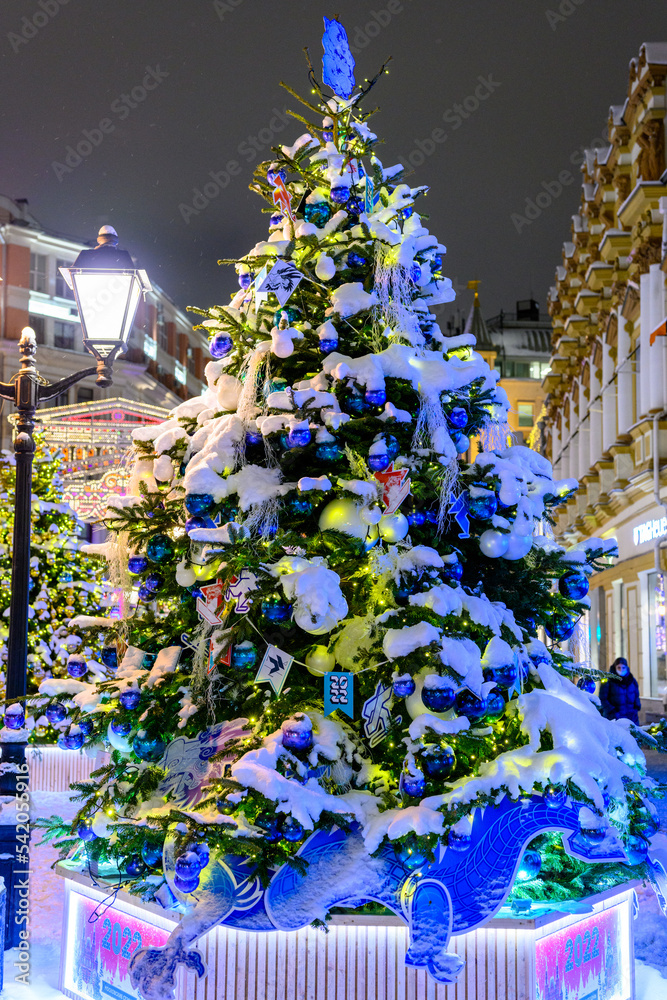 The streets of city decorated with christmas trees and garlands during New Year's Eve. The snowstorm. The streets of city decorated with christmas trees and garlands during New Year's Eve. The snowstorm.
