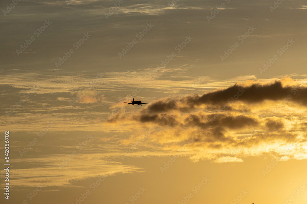 A private jet is about to land to Istanbul Ataturk Airport with the sunset in the background