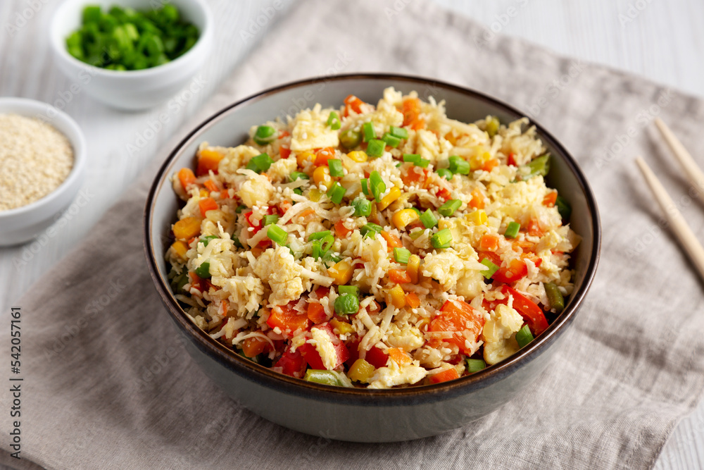 Homemade Cauliflower Fried Rice with Chives and Sesame Seeds in a Bowl, low angle view.
