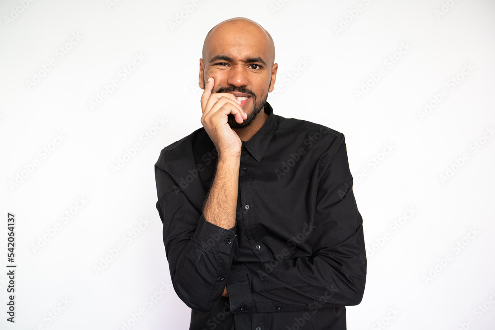 Portrait of curious young businessman looking at camera against white background. Young bearded man wearing black shirt smiling expressing admiration. Curiosity and admiration concept Portrait of curious young businessman looking at camera against white background. Young bearded man wearing black shirt smiling expressing admiration. Curiosity and admiration concept