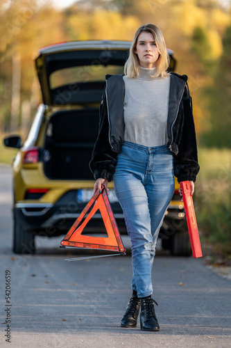 A woman waiting for roadside assistance.