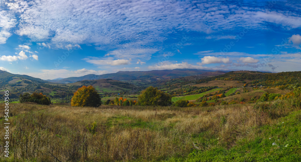Fototapeta premium Autumn landscape backgroun in the sunny weather with clouds