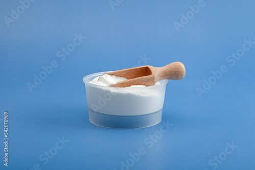 Sodium pyrophosphate or Tetrasodium pyrophosphate (anhydrous) TSPP on blue background. White chemical powder, inorganic compound with formula Na4P2O7. Food additive E450 photo