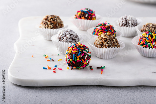 Homemade chocolate truffles covered with sprinkles and nuts photo