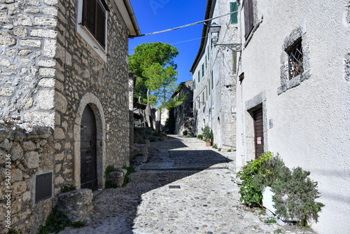 Fototapeta Naklejka Na Ścianę i Meble -  A narrow street between the old stone houses of Civitavecchia di Arpino, a medieval village in the Lazio region, Italy.