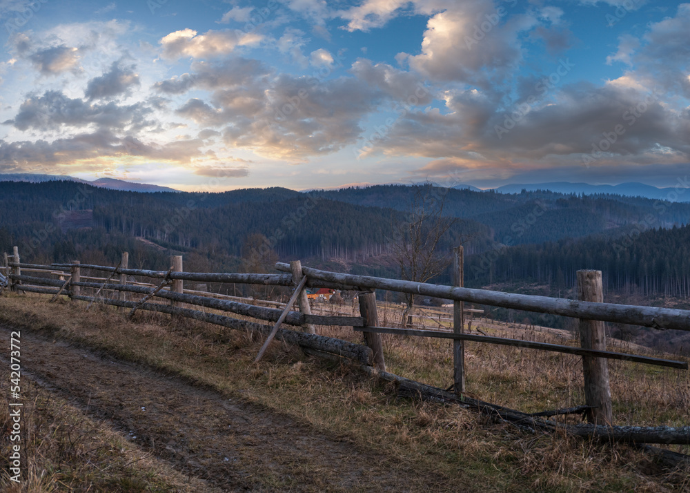 Picturesque pre sunrise morning above late autumn mountain countryside. Ukraine, Carpathian Mountains, Petros top in far. Peaceful traveling, seasonal, nature and countryside beauty concept scene.