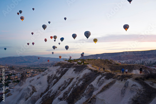 Stunning sunset viewed from bird's eye perspective showing numerous colourful hot air ballon flying over Cappadocia. Turkish touristic attractions. High quality photo