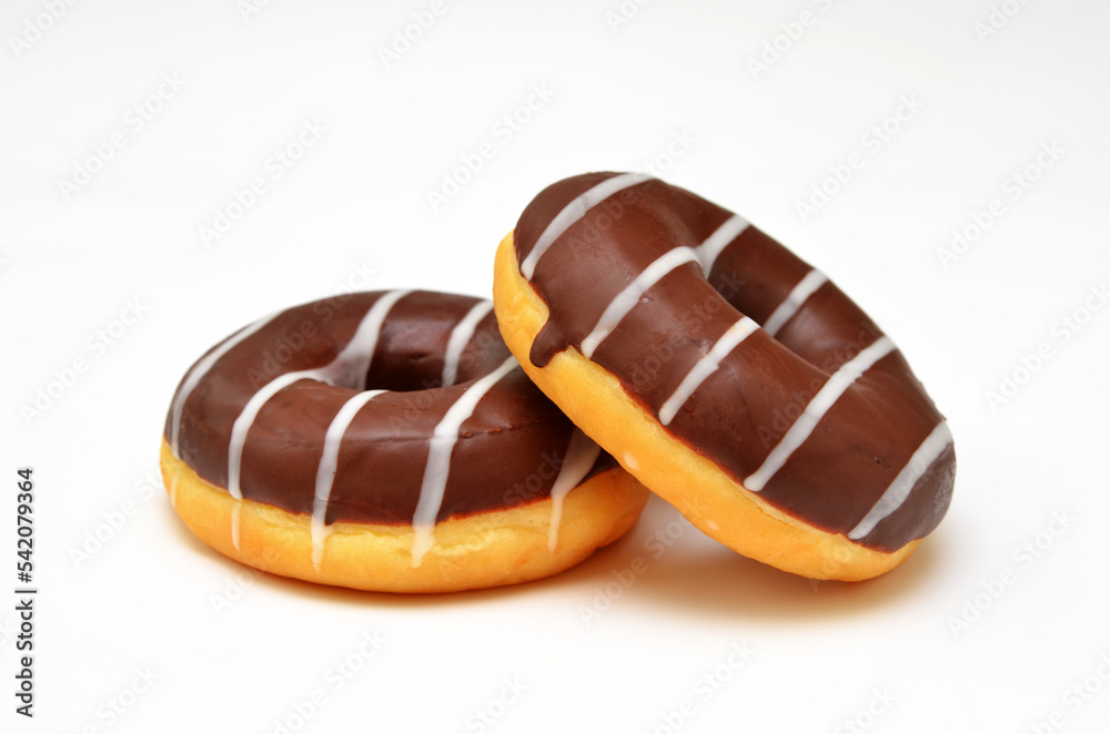 two donuts with chocolate icing isolated on white background close-up two donuts with chocolate icing isolated on white background close-up