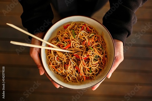 Top view of a person serving chow mein photo