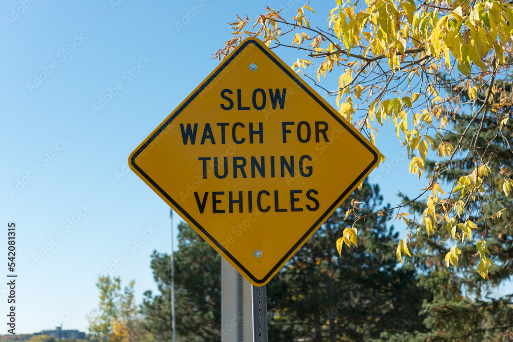 sign on bridge top: slow watch for turning vehicles sign on bridge top: slow watch for turning vehicles