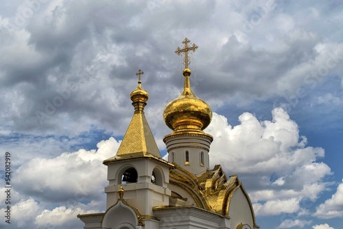 Golden domes of orthodox church. Khabarovsk, St. Seraphim of Sarov Church. Far East, Russia. photo