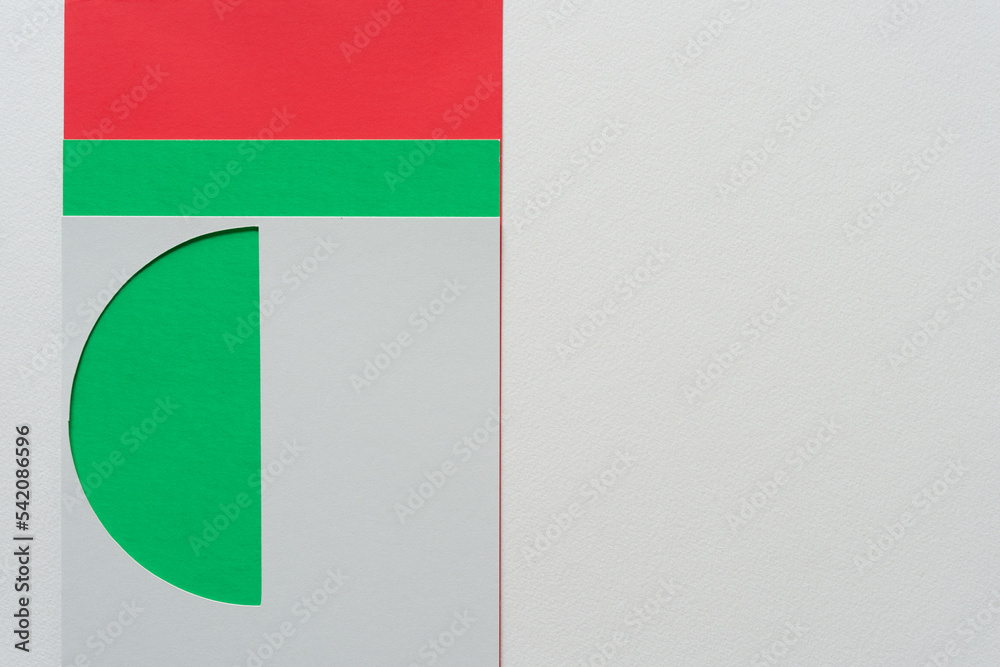 paper stencil with lunette cutout on green, red, and blank paper background paper stencil with lunette cutout on green, red, and blank paper background